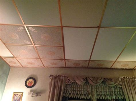 The <strong>ceiling</strong> is in good shape , but there are some smaller holes through the <strong>tiles</strong>. . Old fiberboard ceiling tiles